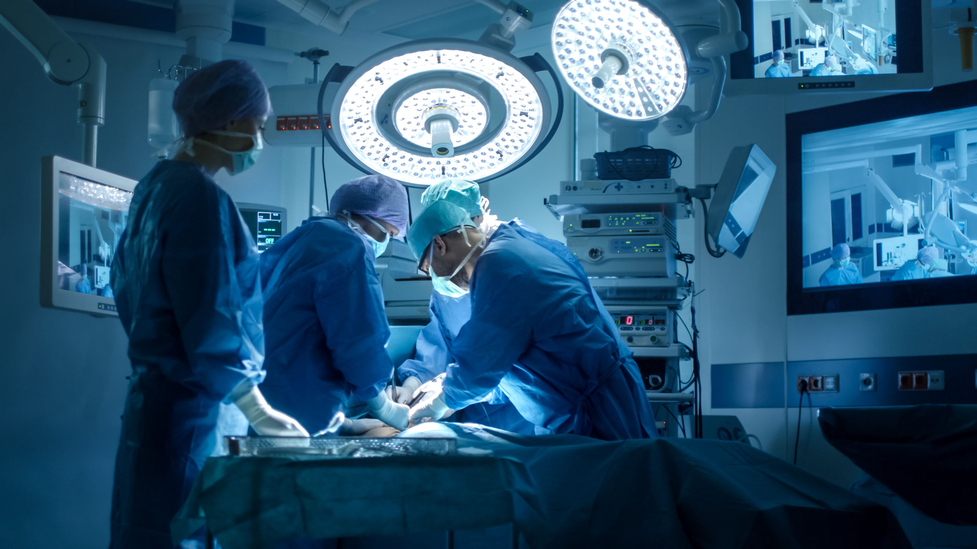 Operating room with surgeons operating on a patient