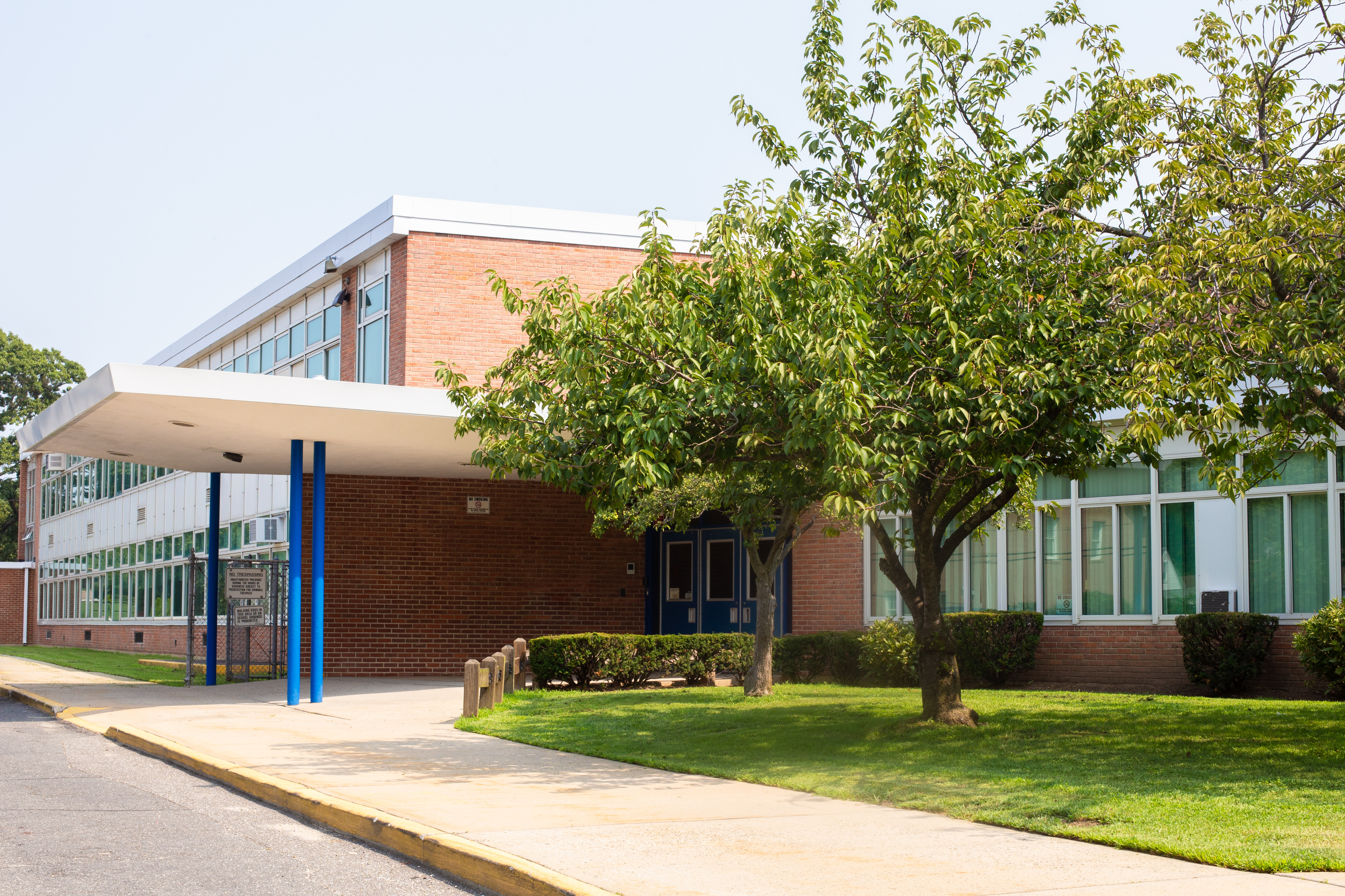 K-12 school buildings exterior with trees
