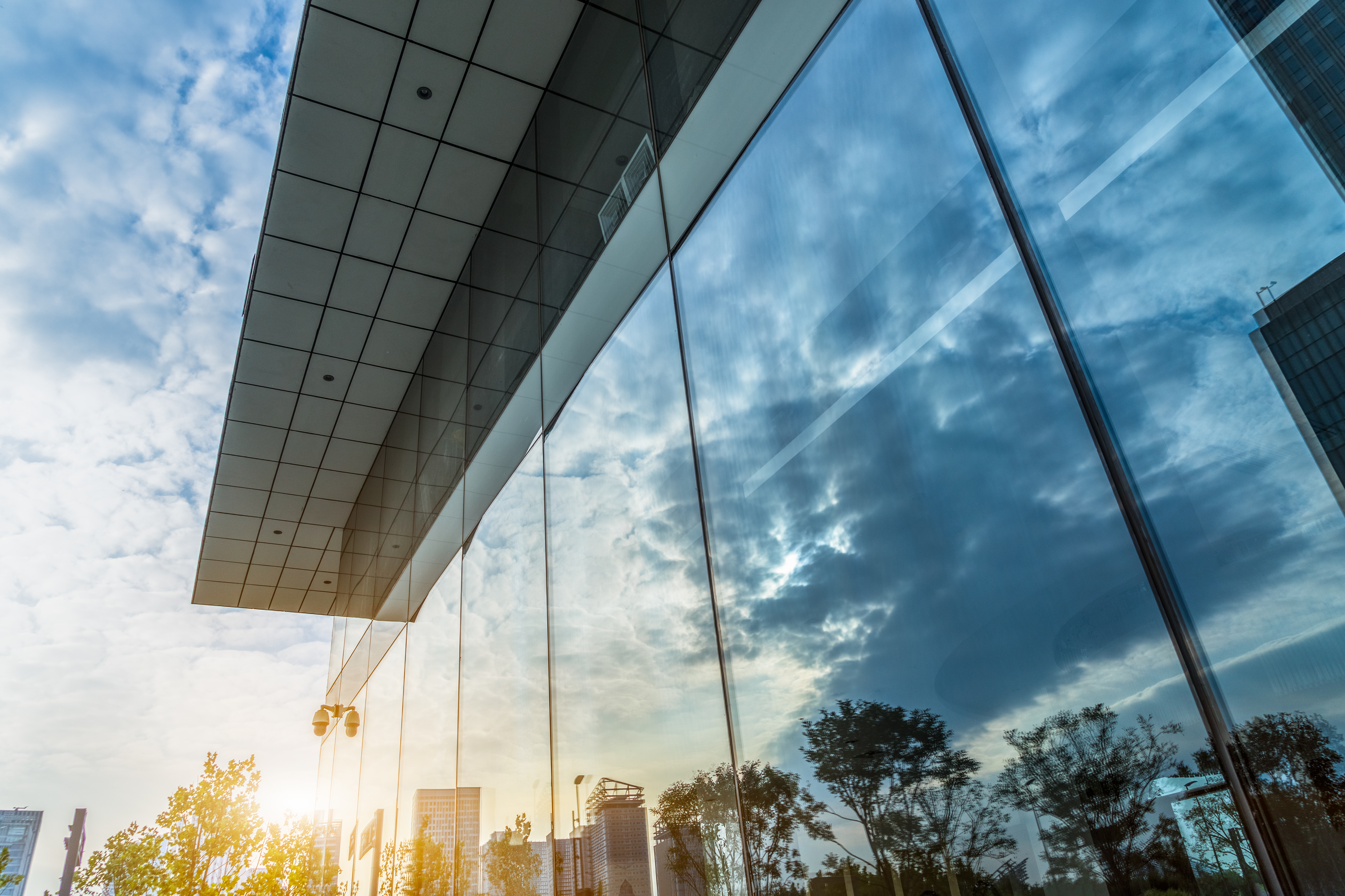 Modern building with glass windows and sun reflection