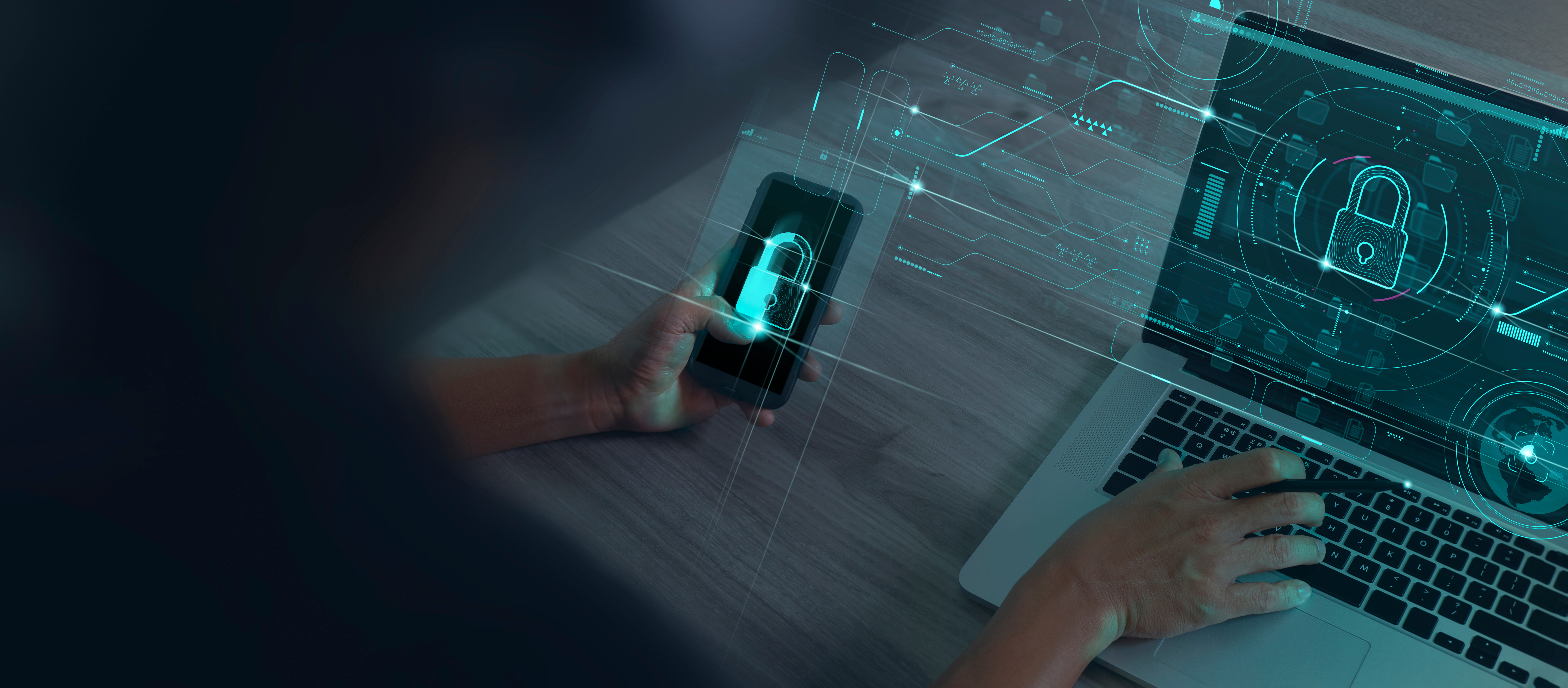 Employee holding phone and laptop using security measures