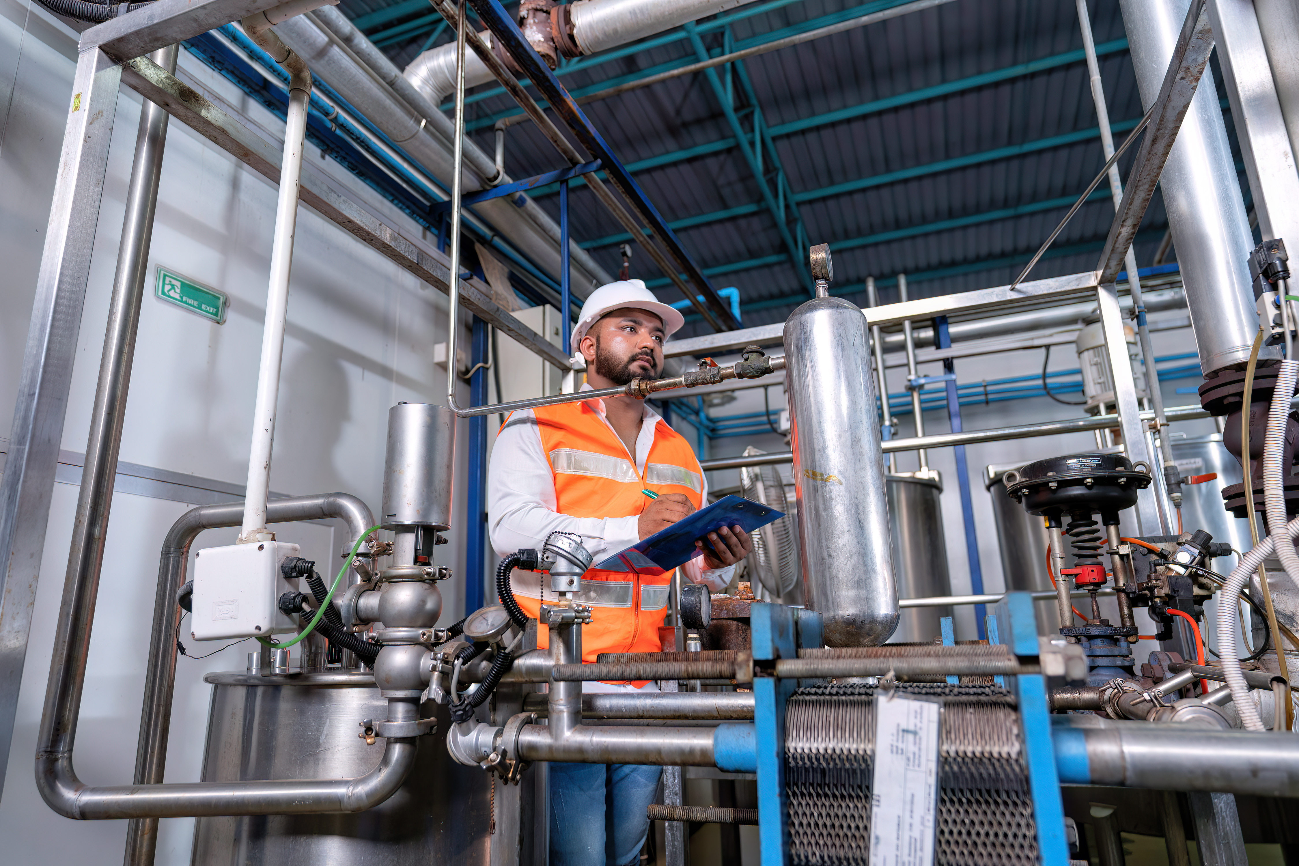Worker with hard hat analyzing equipment