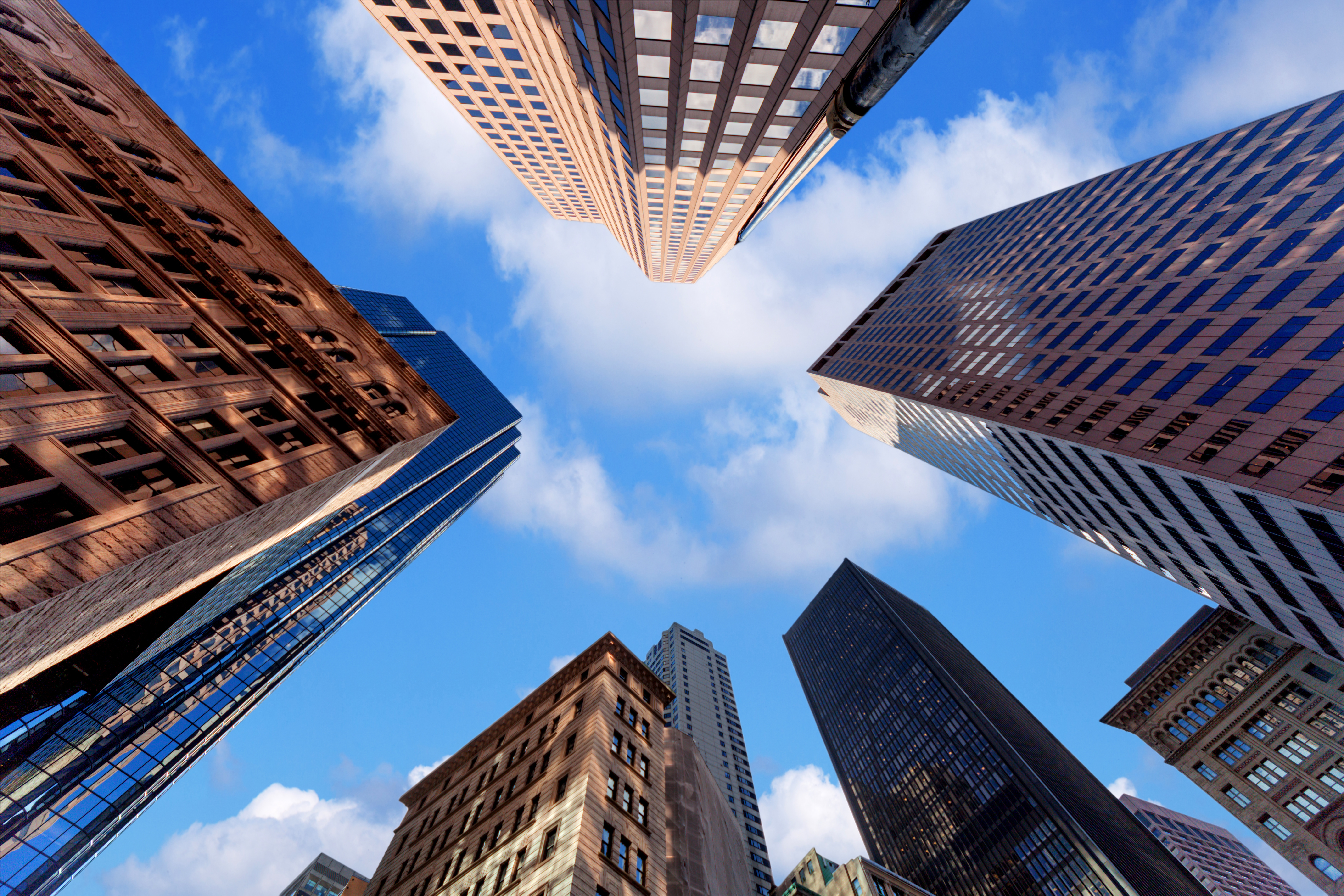 Blue sky with buildings looking up from the ground