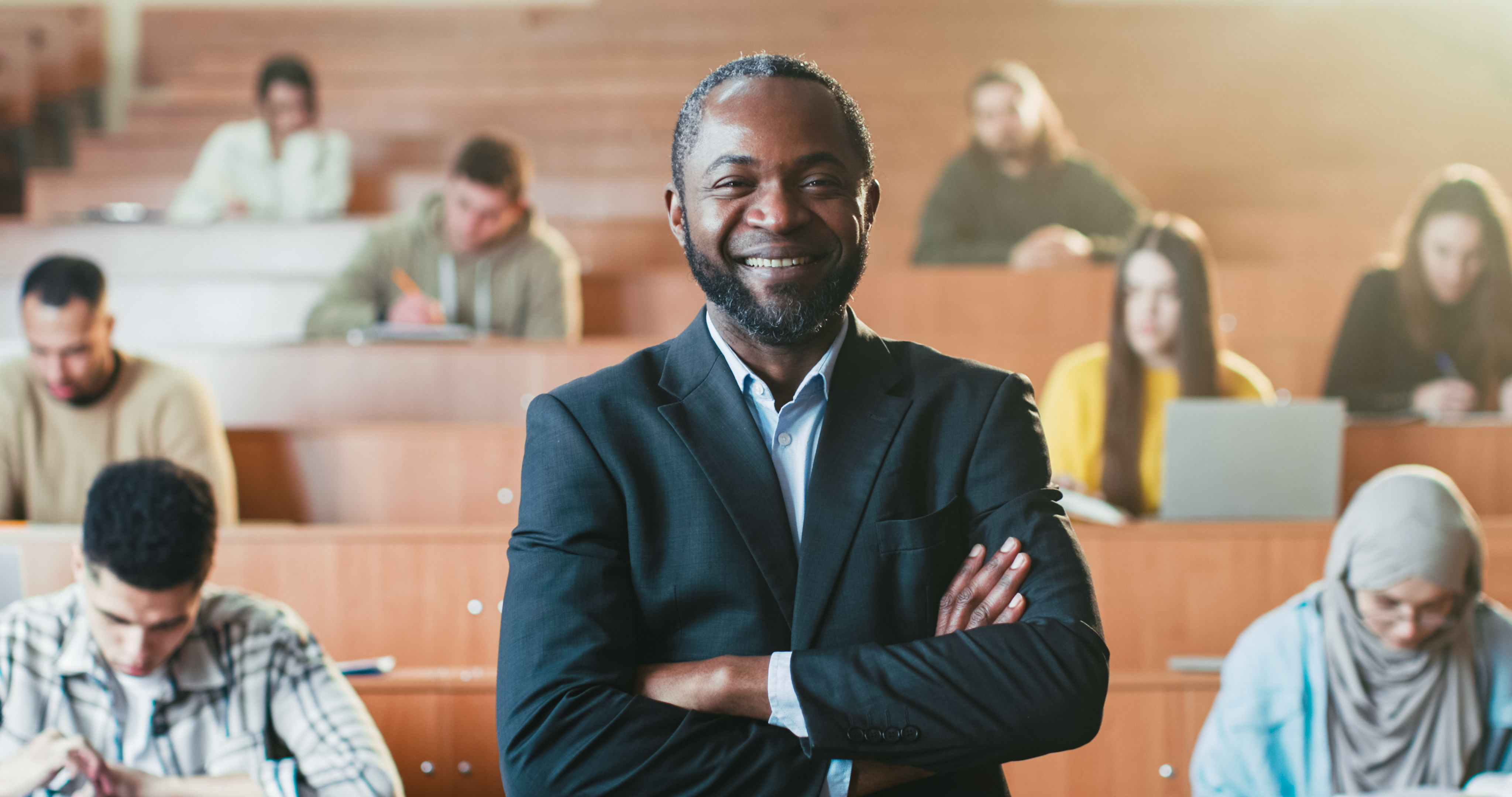 Professor crossing arms infront of college class